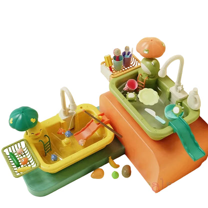Children's toy kitchen set with a sink, stove, and various utensils on a light surface.